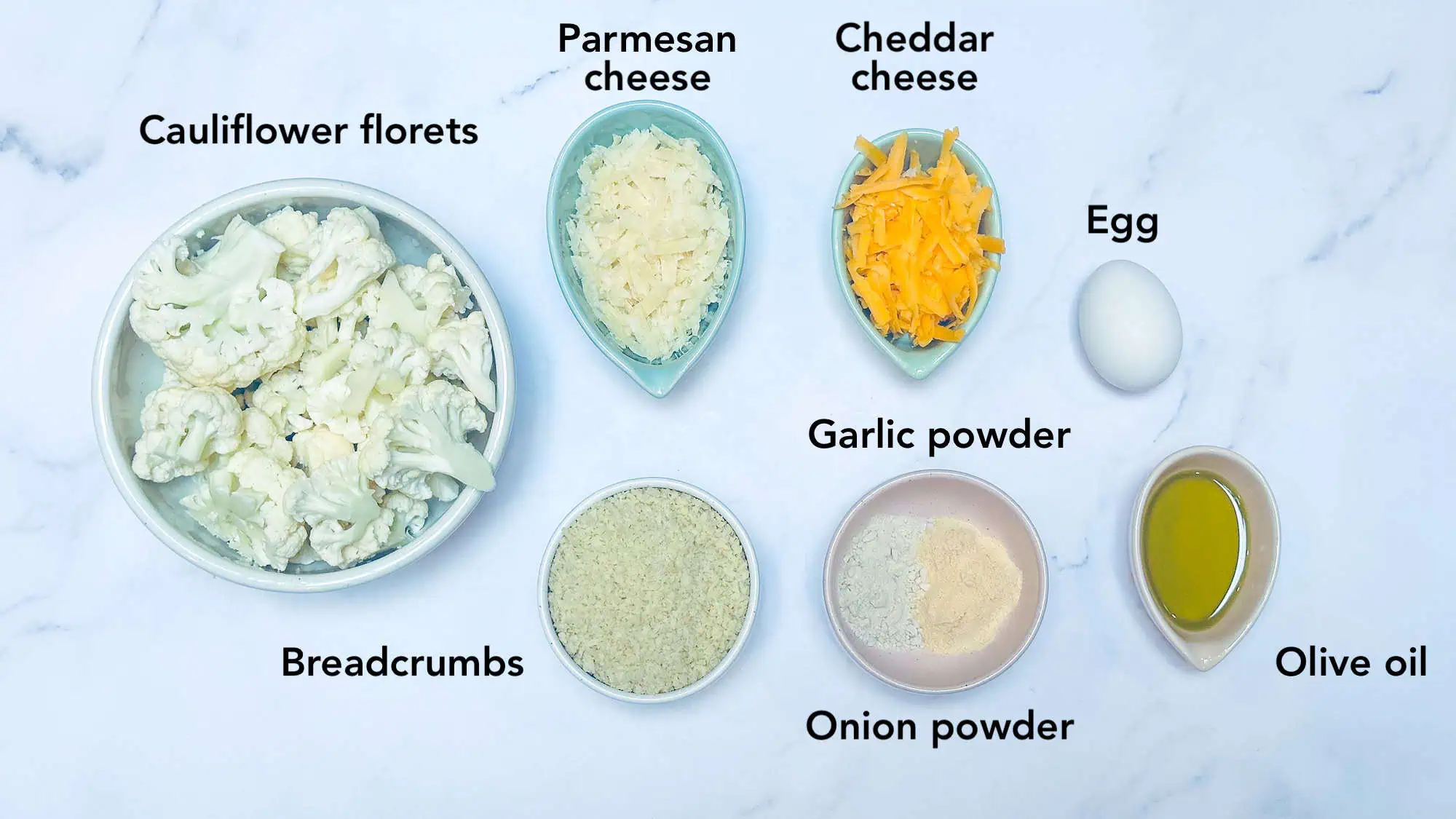 Ingredients for cauliflower tater tots on white marble background