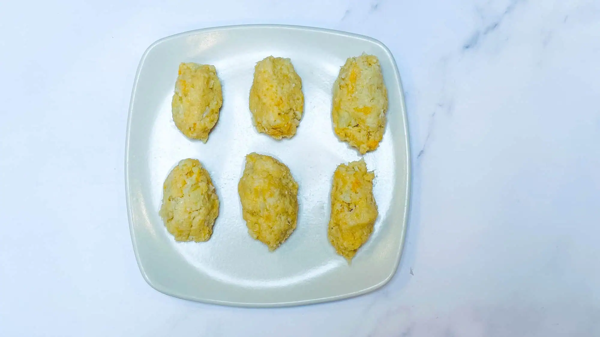 Step 3 for cauliflower tater tots - forming into tot shapes.