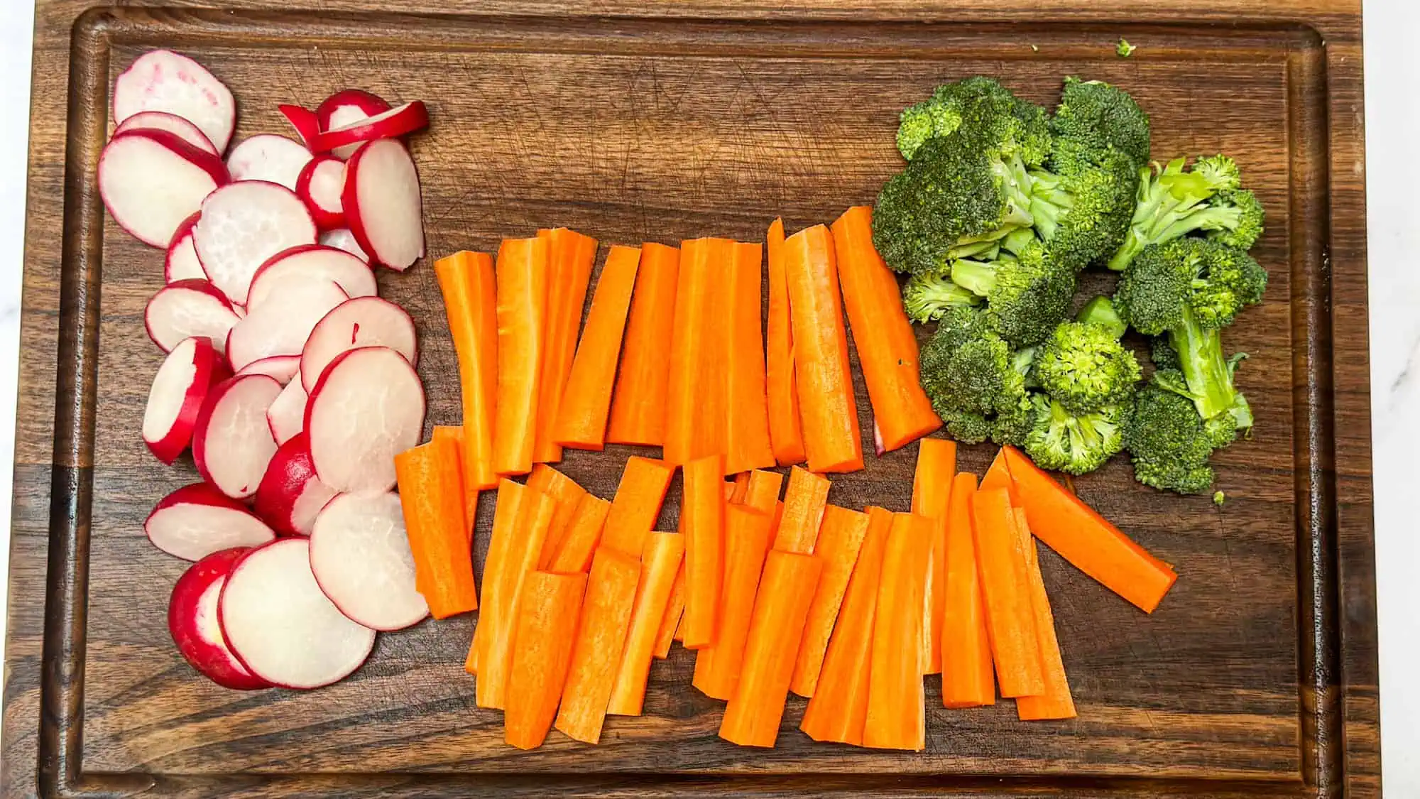 Step 1 for roasted vegetables. Chopped carrots, broccoli and radishes. 