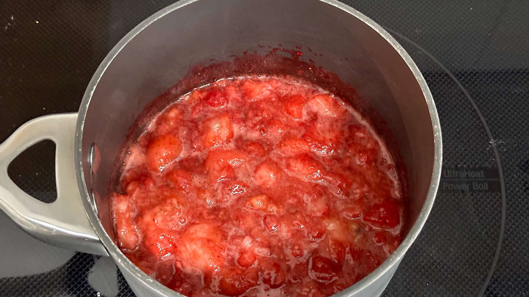 Step 1 of strawberry chia jam, add frozen strawberries to medium sauce pan and heat up until strawberries breakdown.