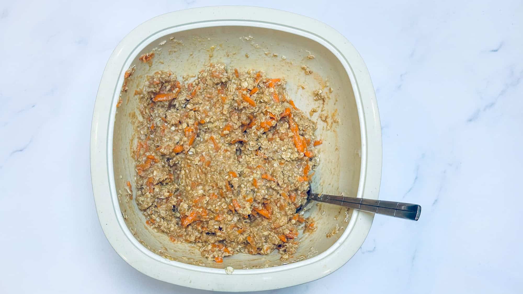 Step 3 for baked carrot cake oatmeal. Stirring all ingredients to combine.