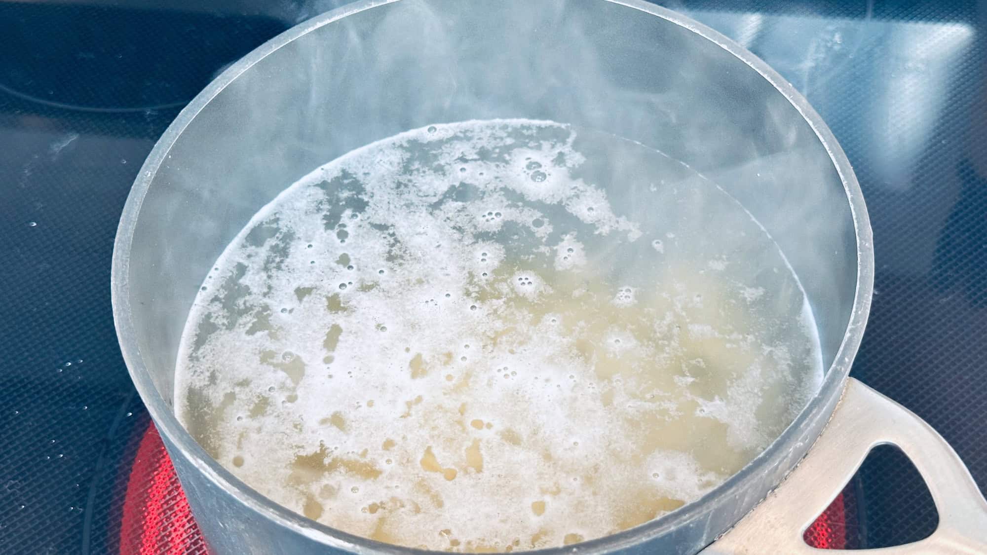 Step 1 of lentil pasta. Bringing water to boil in large pot and add pasta noodles.