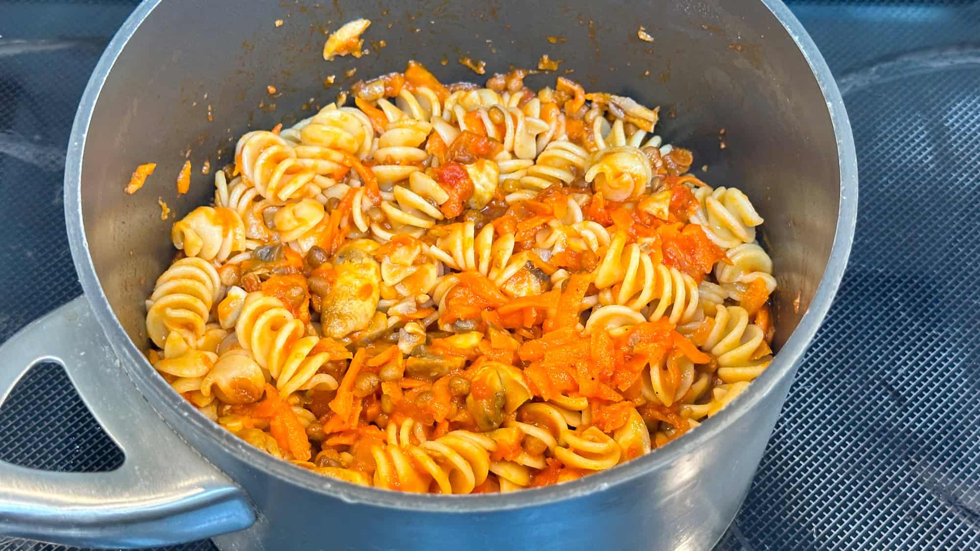 Step 4 of pasta with easy lentil sauce. Add sauce to pasta noodles and stir.