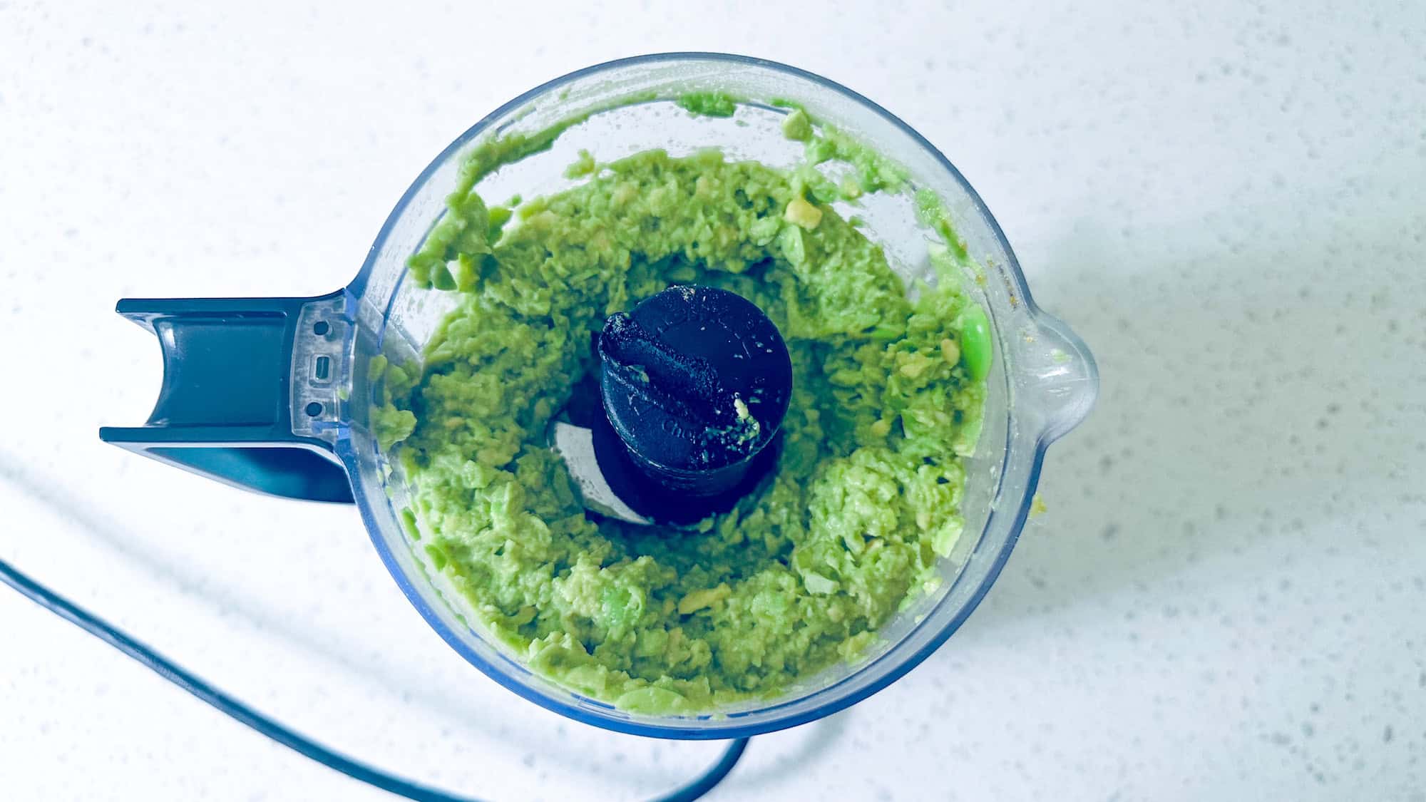 Step 1 for high protein guacamole. Blending ingredients in a food processor.