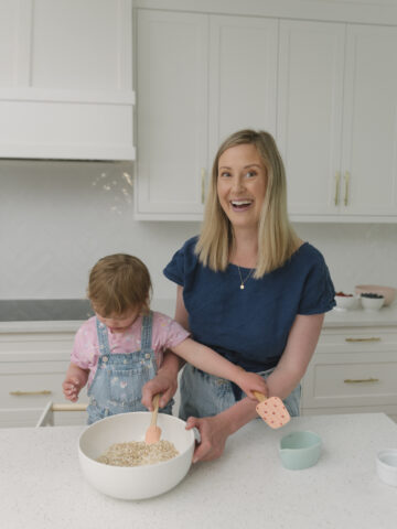 Mom and daughter baking at kitchen counter.