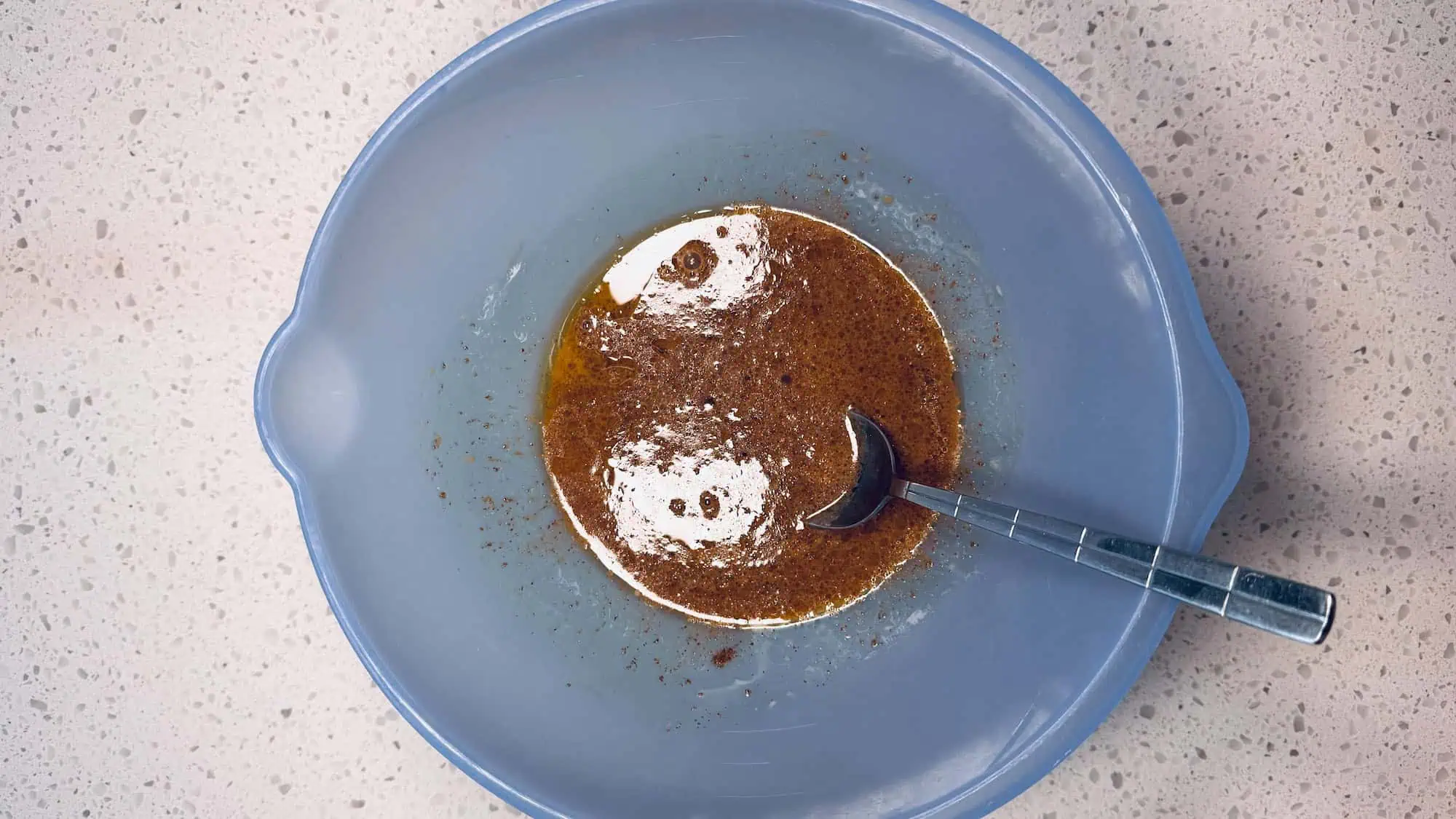 Step 2 of oat nog cookies. In a blue medium bowl, add the brown sugar, oil and vanilla. 