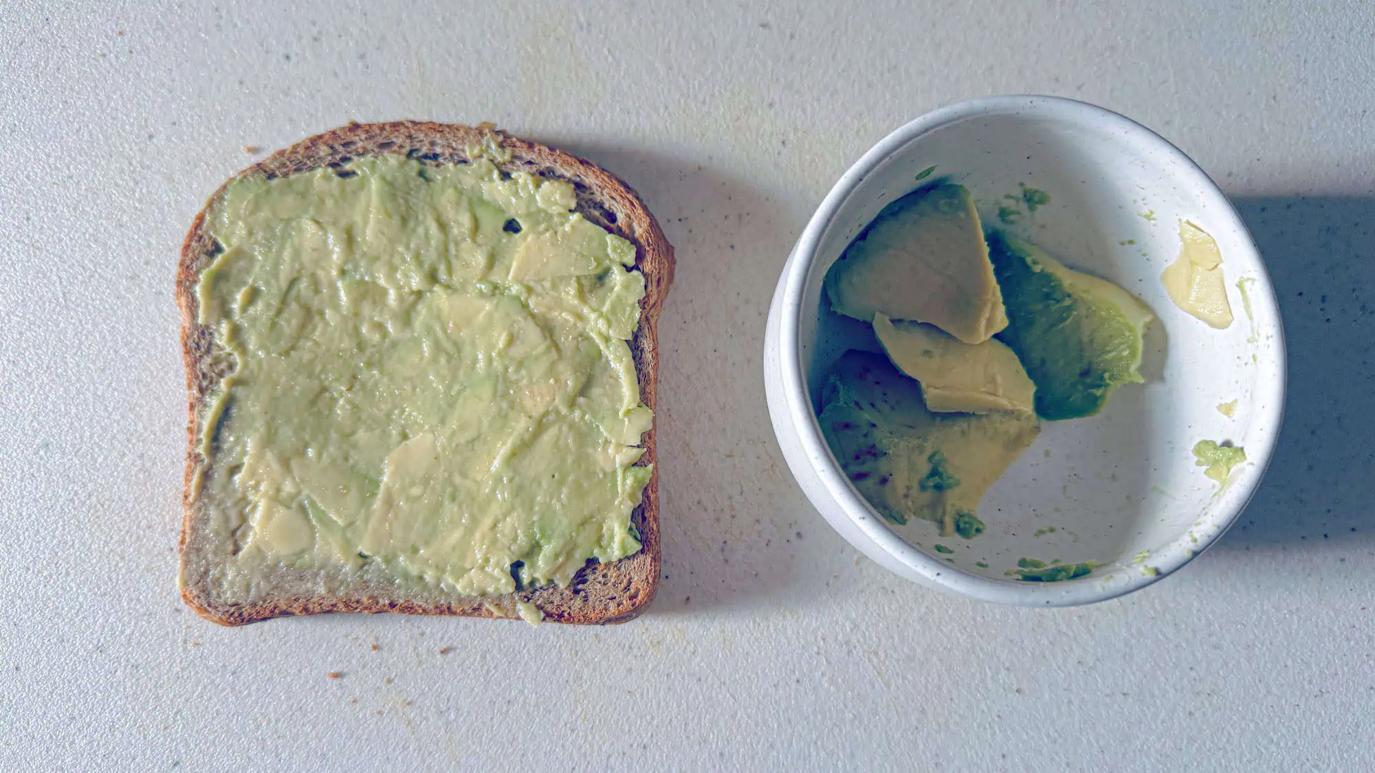 Step 2. Mash avocado and spread in a layer onto the toast.