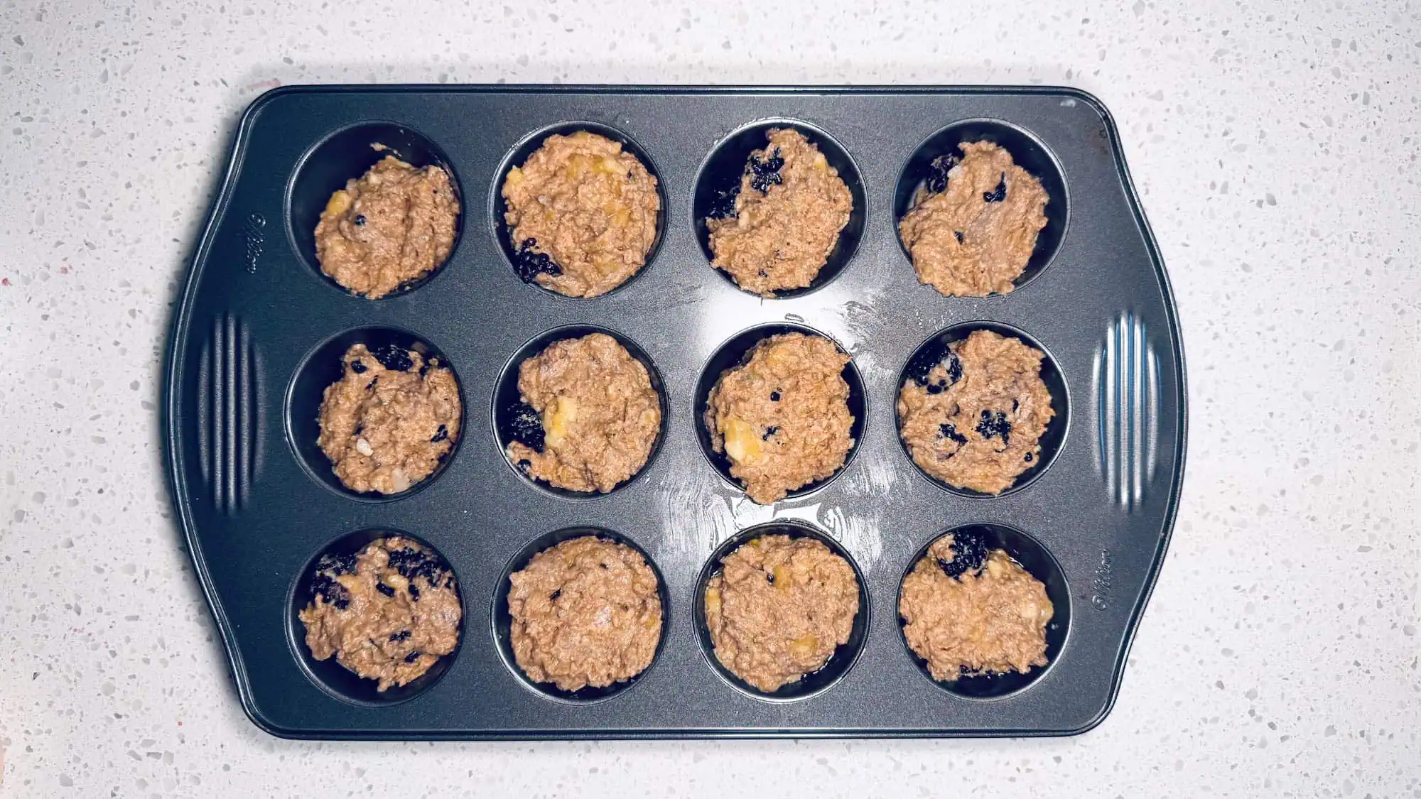 Step 4, batter is spooned out into a muffin pan.