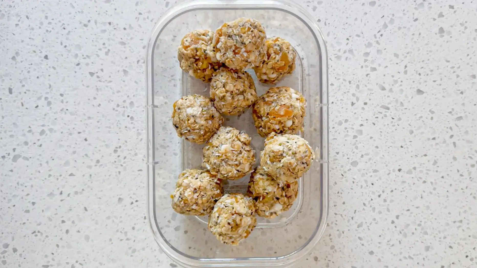 step 4 for making energy balls. Roll dough into balls and place in container to go in the fridge.