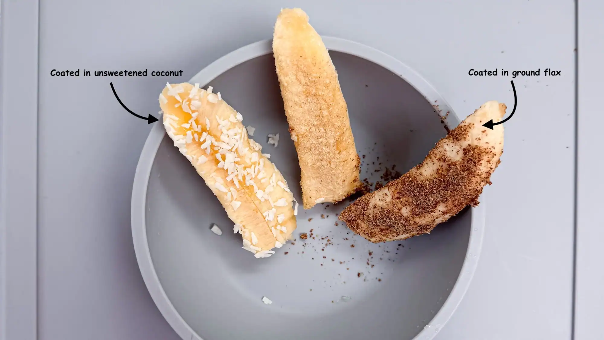 Banana spears in a blue baby bowl coated in coconut and flax seed.